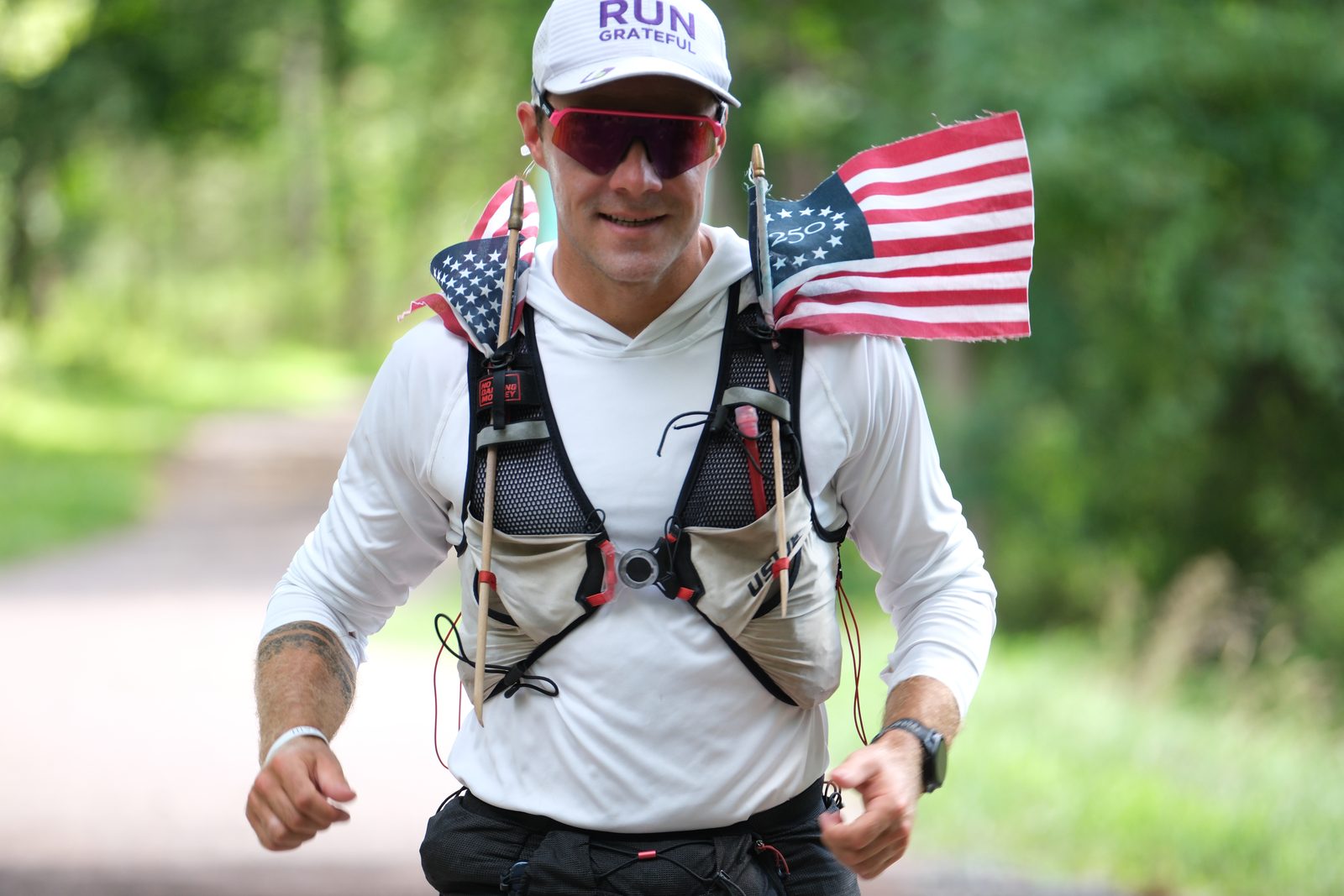 Collin running with American flags on his pack