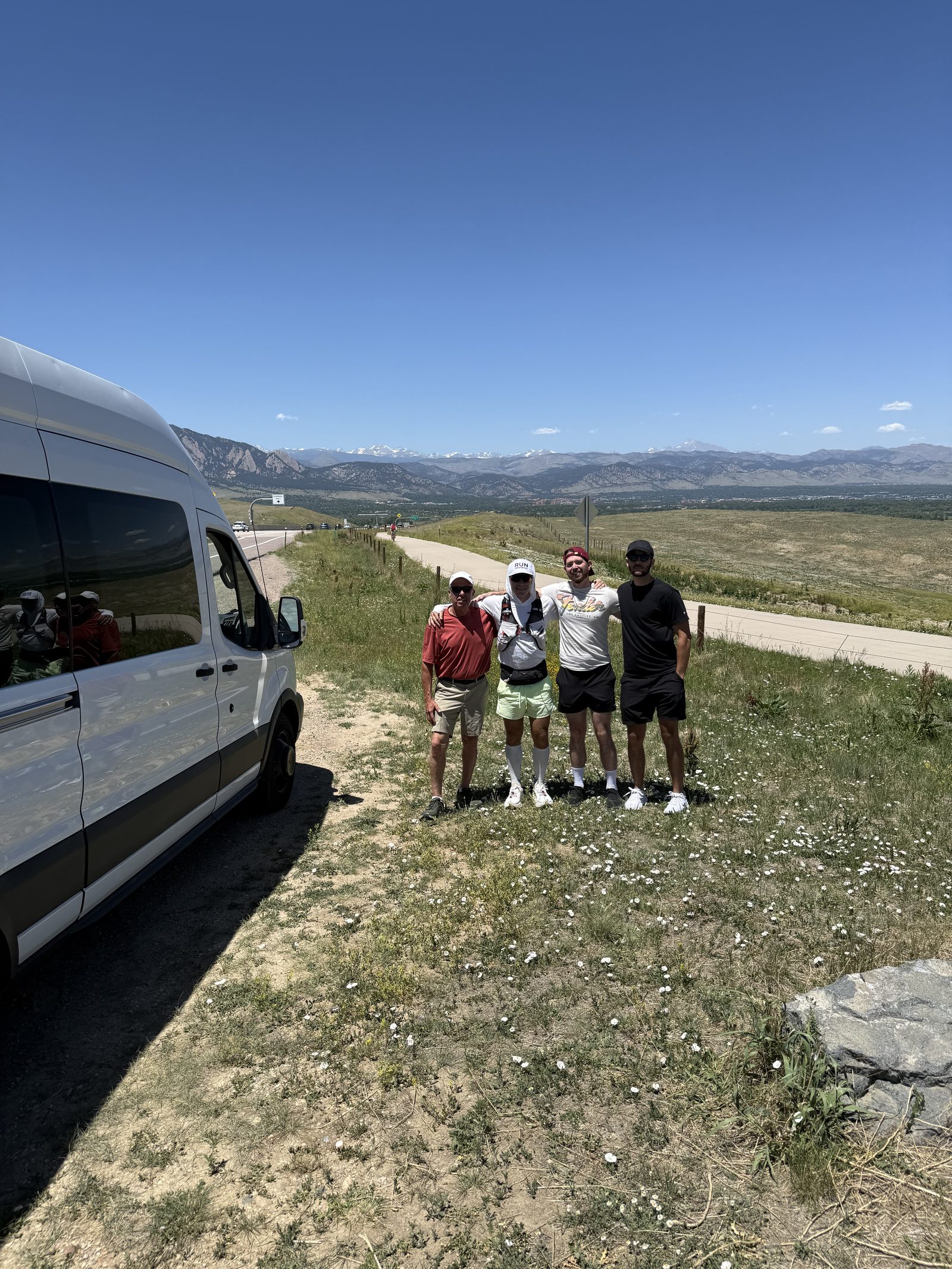 The support van parked on the Colorado plains with mountains on the horizon