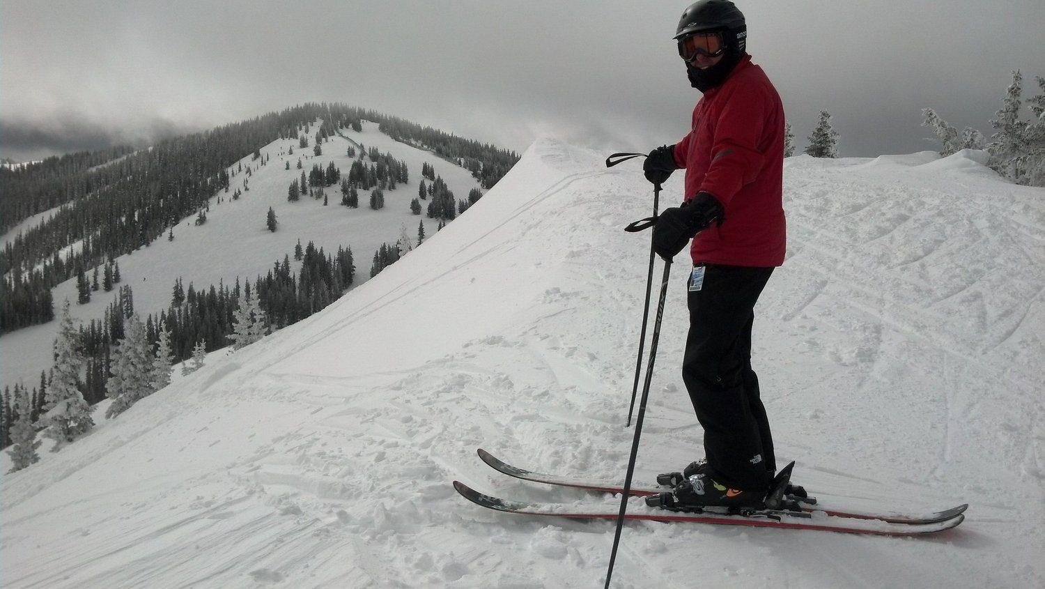 A skier on a snowy ridge